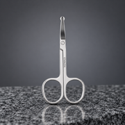 Nicor stainless steel round-tip nose hair scissors on a dark marble tabletop